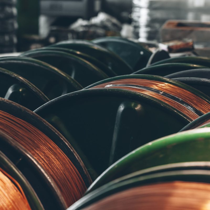 Copper wire reels in cable factory close up photo