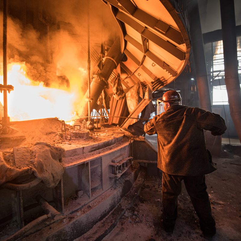 Steelworker at work near the arc furnace